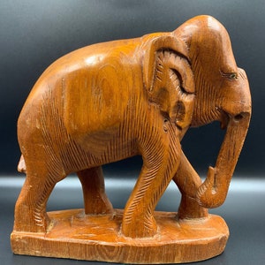 Hand carved Wooden Sculpture of Elephant in a walking posture on wooden base