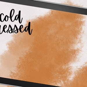 May include: A digital tablet screen displaying a brown watercolor background with the text "cold pressed" in black.