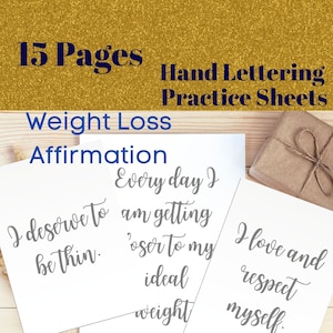 May include: Two white cards with gray text on a wooden surface. The text on the cards reads "I deserve to be thin. Every day I am getting closer to my ideal weight." and "I love and respect myself."