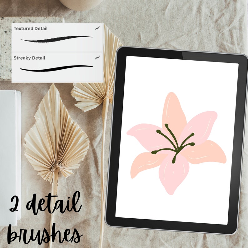 May include: A digital tablet displaying a pink flower with green stems on a white background. The text "2 detail brushes" is visible below the tablet.