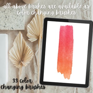 May include: A digital tablet displaying a brush stroke of watercolor paint in shades of red and orange. The text "33 Color Changing Brushes" is visible below the tablet.
