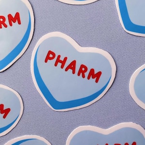 May include: Seven blue heart-shaped stickers with a white outline and the word "PHARM" written in red letters.