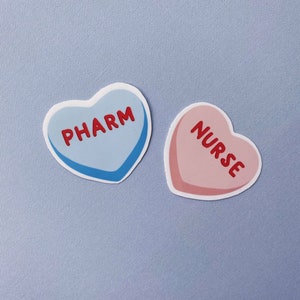 May include: Two heart-shaped stickers, one blue with the word "PHARM" and one pink with the word "NURSE".
