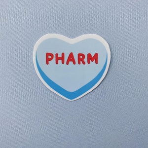 May include: A blue heart-shaped sticker with a white outline and a blue border. The word "PHARM" is written in red letters on the sticker.