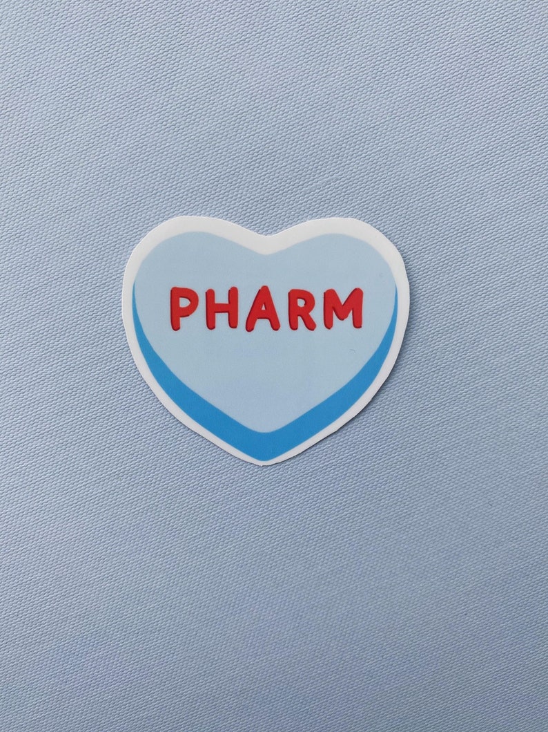 May include: A blue heart-shaped sticker with a white outline and a blue border. The word "PHARM" is written in red letters on the sticker.