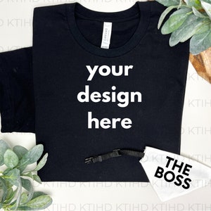 May include: Black t-shirt with white text that says "your design here". A white dog collar with black text that says "THE BOSS" is also pictured.