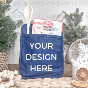 May include: A blue pot holder with a pocket for a wooden spoon and a package of sugar. The pot holder has the text "YOUR DESIGN HERE" printed on it.