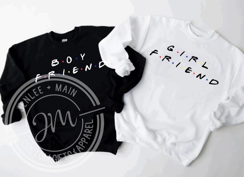 May include: Two black and white sweatshirts with the words "Boyfriend" and "Girlfriend" in colourful letters. The sweatshirts are a matching set.
