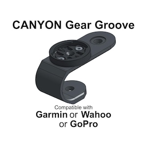 May include: Black "CANYON Gear Groove" bicycle accessory mount, compatible with Garmin or Wahoo or GoPro devices. The mount has a curved base with two holes for attachment and a circular top with a central mounting point.