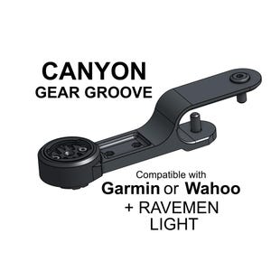 May include: A black Canyon Gear Groove bicycle mount featuring a circular interface for a cycling computer and an extended arm with two mounting pins. Text reads: CANYON GEAR GROOVE, Compatible with Garmin or Wahoo + RAVEMEN LIGHT.