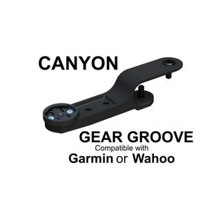 May include: Black Gear Groove bike computer mount compatible with Garmin or Wahoo devices. The mount is designed for Canyon bikes. The word "CANYON" is printed in bold black letters above the mount.
