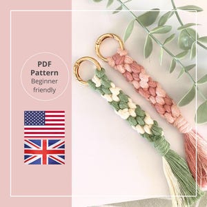 May include: Two macrame keychains with gold clasps. One is green and white, the other is pink. Both have tassels. The image includes text that says "PDF Pattern Beginner friendly".