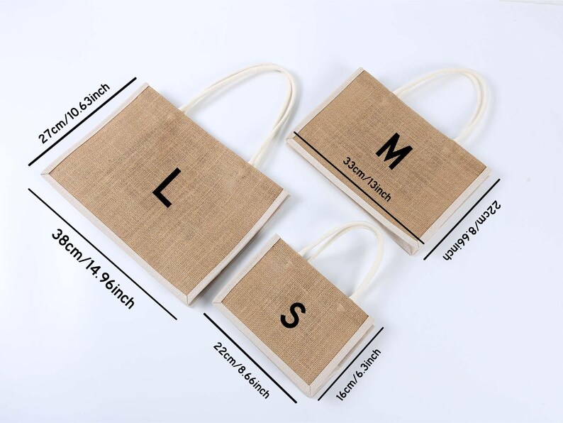 May include: Three rectangular jute tote bags with white handles, labeled L, M, and S. The largest bag is 38cm/14.96 inches long, the medium bag is 33cm/13 inches long, and the smallest bag is 22cm/8.66 inches long. The bags are on a white surface.