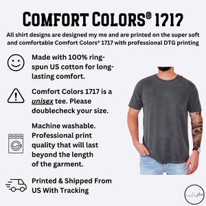 May include: A dark gray Comfort Colors 1212 unisex t-shirt. The image includes text about the shirt's features, including 100% ring-spun US cotton, machine washability, and professional print quality. A person is wearing the shirt.