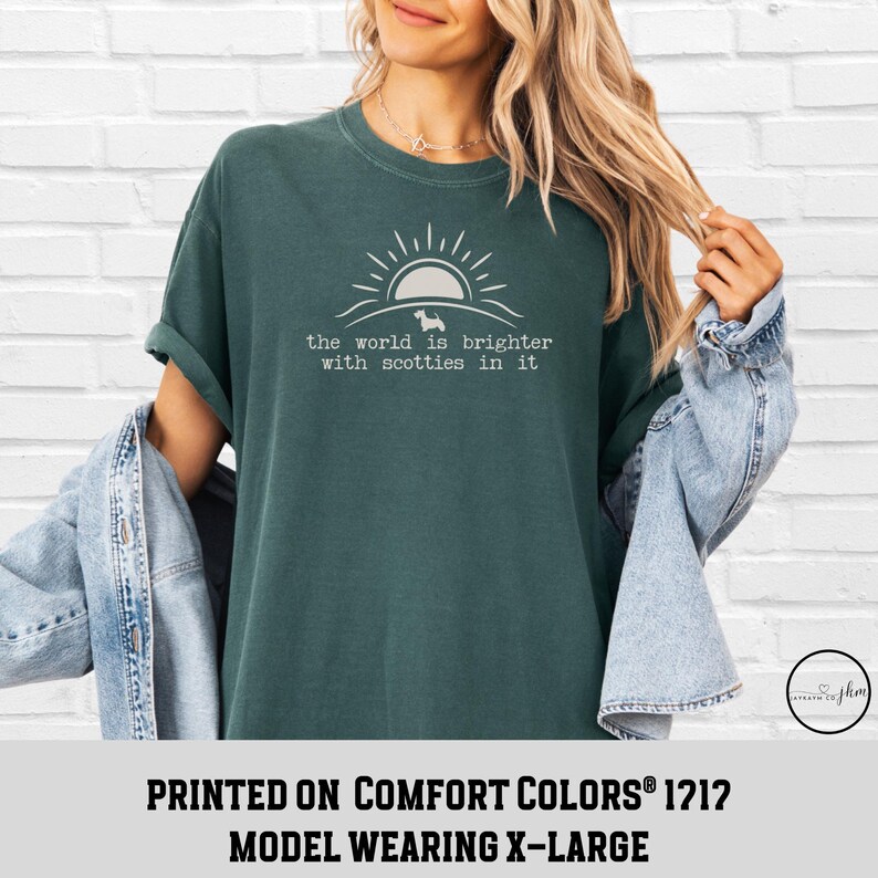 May include: Dark teal t-shirt with the text "the world is brighter with scotties in it" in white. The design includes a sun and a silhouette of a dog. The shirt is a Comfort Colors 1212 model, size X-Large.