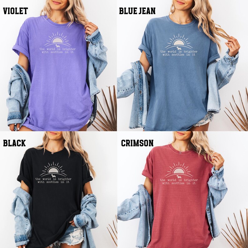 May include: Four t-shirts in violet, blue jean, black, and crimson. Each shirt has a graphic of a sun, a dog, and the text "the world is brighter with scotties in it."