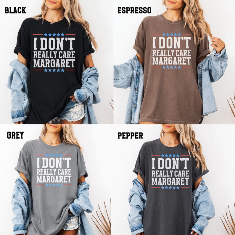 May include: A graphic tee shirt with the text "I don't really care Margaret" in white with red and blue stars. The shirt is available in four colors: black, espresso, grey, and pepper.