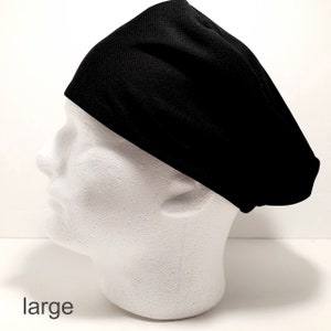 May include: Black scrub hat with the word "large" printed below it.