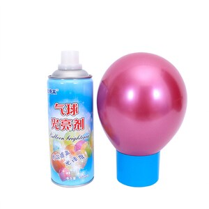 May include: A pink balloon on a blue base next to a blue spray can. The spray can has white text and colorful balloon illustrations. The text on the can reads "Balloon brightener". The balloon is round and shiny.