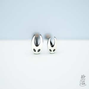 May include: A set of three ceramic mugs with a speckled, matte finish. The mugs are in shades of cream, light gray, and dark gray. Each mug has a simple, minimalist design, perfect for coffee or tea.