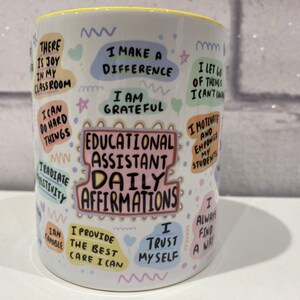 May include: White ceramic mug with colourful text and illustrations. The text reads "Educational Assistant Daily Affirmations" and includes phrases like "I make a difference", "I am grateful", "I radiate positivity", and "I trust myself".