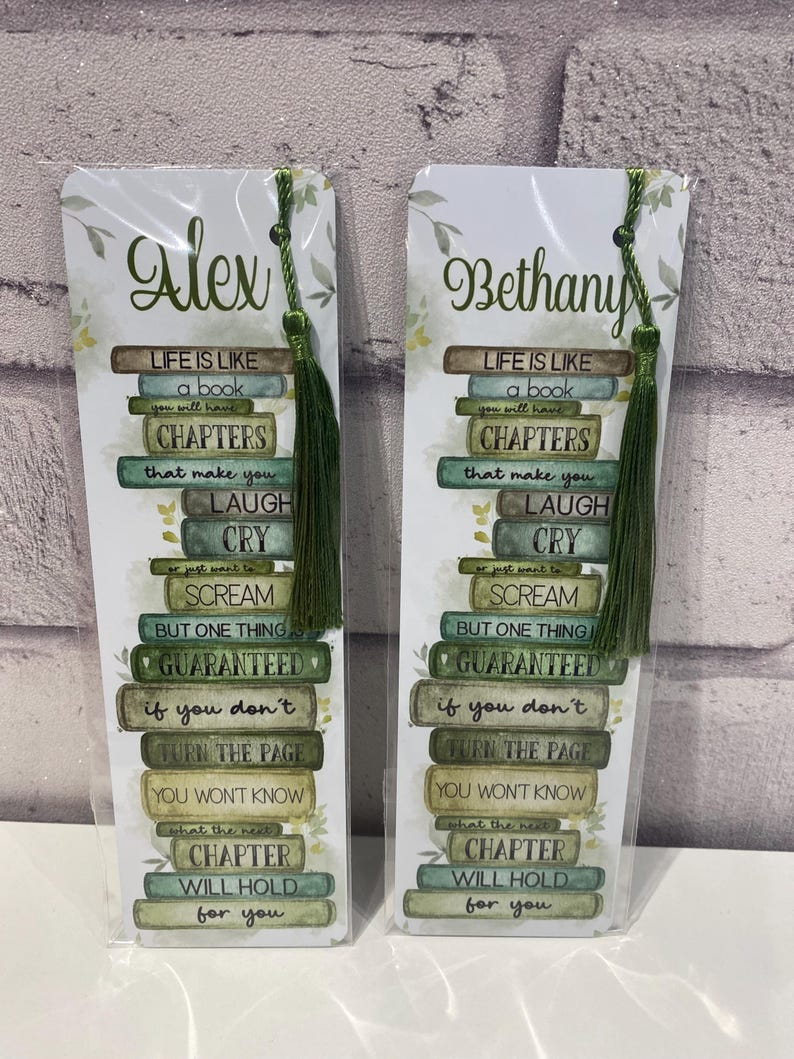 May include: Two personalized bookmarks with green tassels. Each bookmark features the name "Alex" or "Bethany" in script, with a quote about life and reading. The quote is arranged to look like a stack of books.