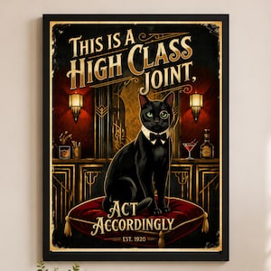 May include: A framed vintage-style poster with a black cat wearing a bow tie and monocle, sitting on a red cushion. The poster reads "THIS IS A HIGH CLASS JOINT, ACT ACCORDINGLY, EST. 1920" in gold lettering, set against a dark background.