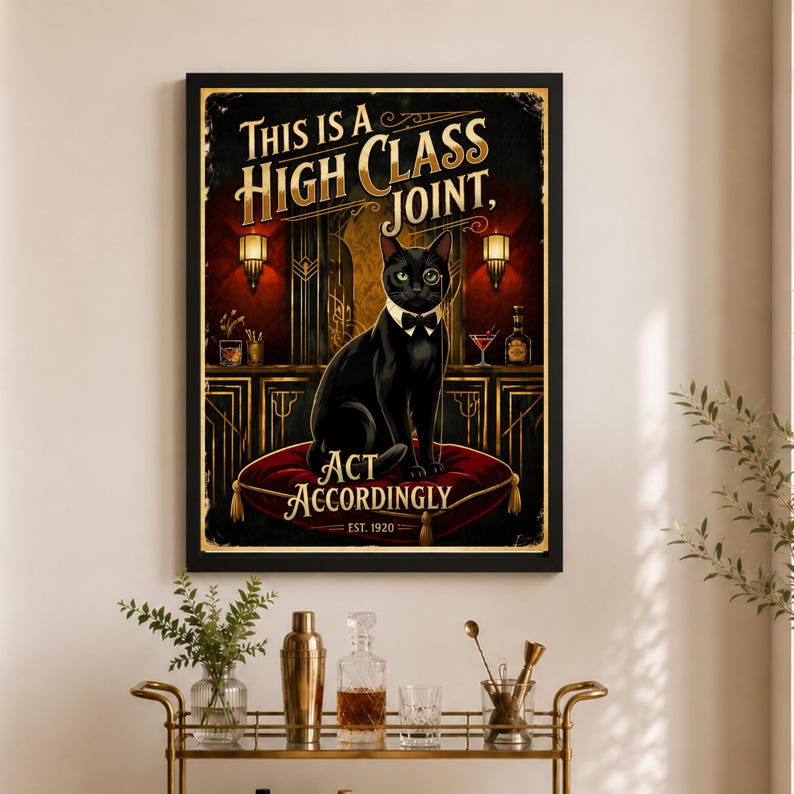 May include: A framed vintage-style poster with a black cat wearing a bow tie and monocle, sitting on a red cushion. The poster reads "THIS IS A HIGH CLASS JOINT, ACT ACCORDINGLY, EST. 1920" in gold lettering, set against a dark background.