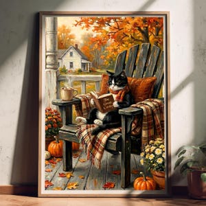 May include: A framed print depicting a black and white cat wearing glasses and a scarf, sitting in a wooden chair on a porch. The cat holds a book titled The Great Gatsby. A steaming mug, pumpkins, and autumn foliage are visible in the scene.
