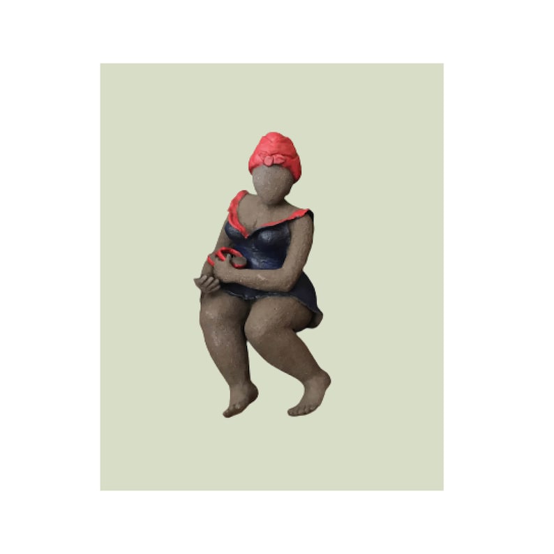 French manufacturing. Ceramic sculpture of a woman in a dark blue dress with a red turban