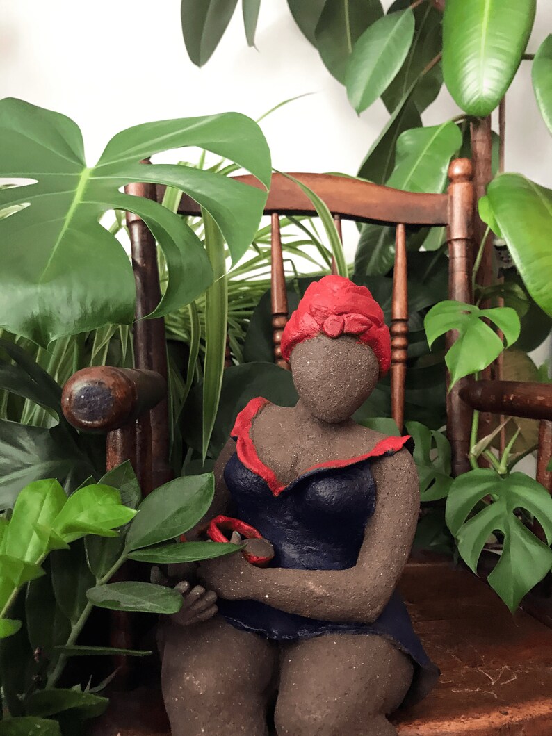 French manufacturing. Ceramic sculpture of a woman in a dark blue dress with a red turban