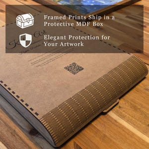 May include: A flat, rectangular brown MDF box with a laser-cut, slatted curved edge design. The top surface features printed text, a QR code, and icons of a treasure chest and a shield. The text reads: Framed Prints Ship in a Protective MDF Box.