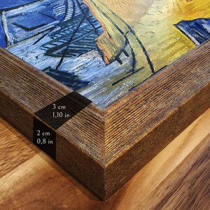 May include: A framed painting featuring textured blue and yellow brushstrokes. The dark brown wooden frame has a ribbed surface texture. The frame measures 3 cm in width and 2 cm in depth as indicated by the printed text labels on the frame.