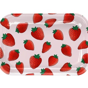 May include: A pink rectangular tray with a repeating pattern of red strawberries. The tray is made of metal and has a glossy finish.