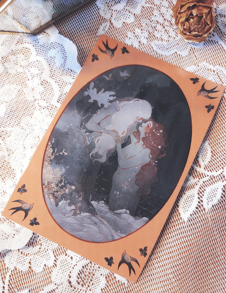 May include: A watercolor illustration of two figures embracing in a dark forest setting. The figures are depicted in a romantic pose, with the woman's hair flowing down her back and the man's arm around her waist. The background is a dark forest with trees and foliage. The illustration is framed in a brown oval with a white border. There are small black birds with white wings on the corners of the frame.