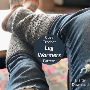 May include: Cozy Crochet Leg Warmers Pattern - Digital Download. A pair of gray crochet leg warmers are worn over blue jeans.