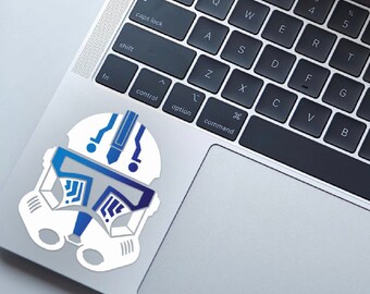 May include: A white and blue Star Wars clone trooper helmet sticker. The helmet has a blue visor and a white design with blue accents.