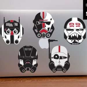 May include: Five black and white helmet stickers with red accents. The helmets are from the Star Wars universe. The stickers are perfect for laptops, water bottles, or other smooth surfaces.