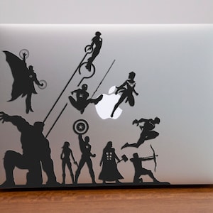May include: Black silhouette stickers of various Marvel superheroes on a silver laptop. The superheroes include Iron Man, Captain America, Thor, Hulk, Black Widow, Hawkeye, and Spider-Man.