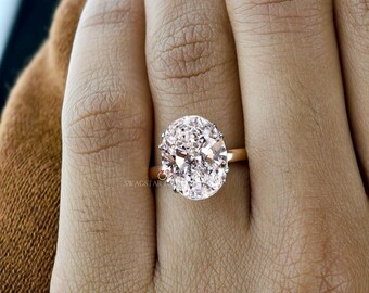 4 karaat ovale verlovingsring met laboratoriumdiamanten: 14 kt roségoud met dubbele stekels