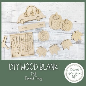 May include: DIY wood blank craft kit for a tiered tray with a "Hello Fall" sign, pumpkins, leaves, and a car with pumpkins on top.