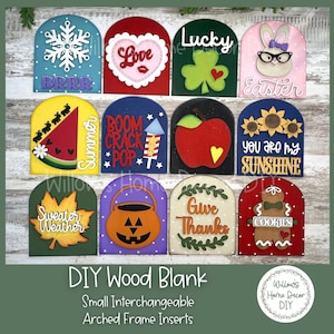 May include: A set of 10 DIY wood blanks with arched frames and interchangeable inserts. The inserts feature various designs and sayings, including "BRRR", "Love", "Lucky", "Easter", "Summer", "Boom Crack Pop", "You Are My Sunshine", "Sweater Weather", "Give Thanks", and "Cookies".