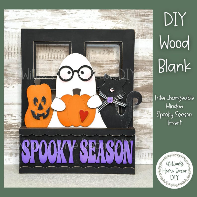 May include: A black wooden window frame with a spooky season insert. The insert features a ghost holding a pumpkin, a black cat, and a pumpkin with a jack-o-lantern face. The window frame has the words "Spooky Season" written in purple letters.