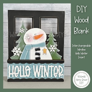 May include: DIY wood blank with a black frame and a window insert that says "Hello Winter". The window insert features a snowman with a blue scarf and a star, and two green trees with snowflakes.