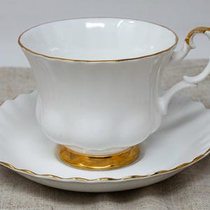 Royal Albert teacup and saucer set, Val D&#39;or pattern, white and gold, fluted edges, Montrose, England