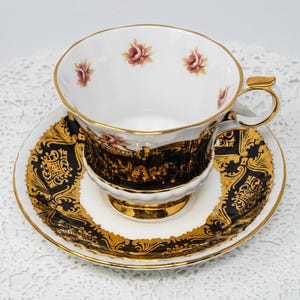 Paragon &quot;Pembroke&quot; teacup and saucer, black with filigree gold and rose buttons, vintage bone china made in England