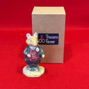 May include: A ceramic mouse figurine wearing a green jacket, red waistcoat, and dark blue trousers, standing on a yellow base. A brown box with a "Treasures Forever" sticker is behind the figurine. The background is red.