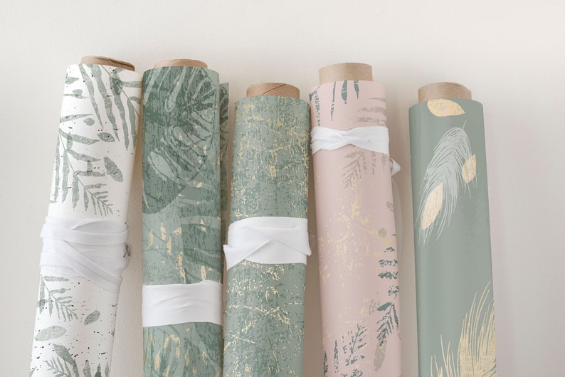 May include: Five rolls of green and gold patterned wrapping paper with white ribbon ties. The patterns include leaves, feathers, and abstract designs.