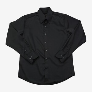 May include: A solid black long-sleeve button-down shirt. The shirt has a classic collar, buttoned cuffs, and a curved hem. The shirt is made of a smooth, opaque fabric.