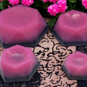 May include: Four pink and black ombre geometric bowls of varying sizes. The bowls are made of a smooth, glossy material and have a unique, faceted design.